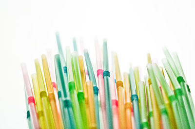 Close-up of colored pencils over white background