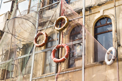 Low angle view of window hanging on building