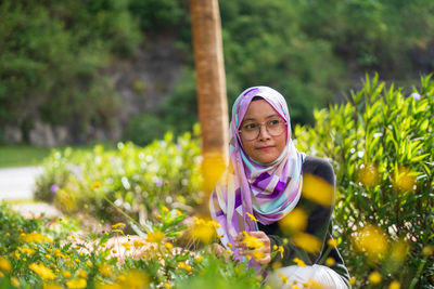 Full length of woman with pink flowers