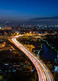 High angle view of light trails on highway at night