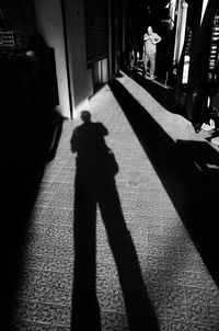 Shadow of man walking on floor