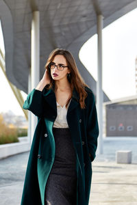 Young woman wearing hat standing outdoors