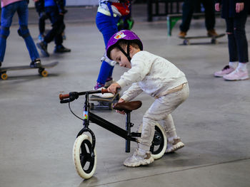 High angle view of boy riding push scooter on street