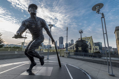 Full length of young man standing against sky in city