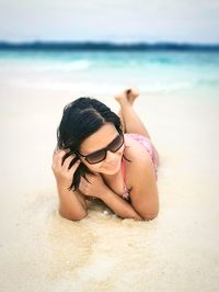 Woman lying on beach