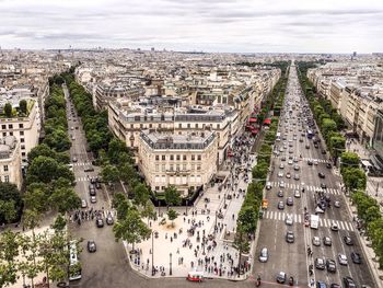 Aerial view of cityscape with people and vehicles on road