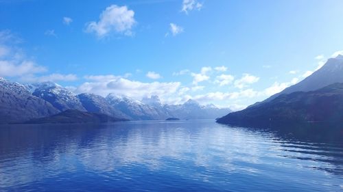 Scenic view of sea and mountains against sky