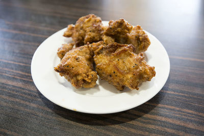 High angle view of fried chicken in plate on table