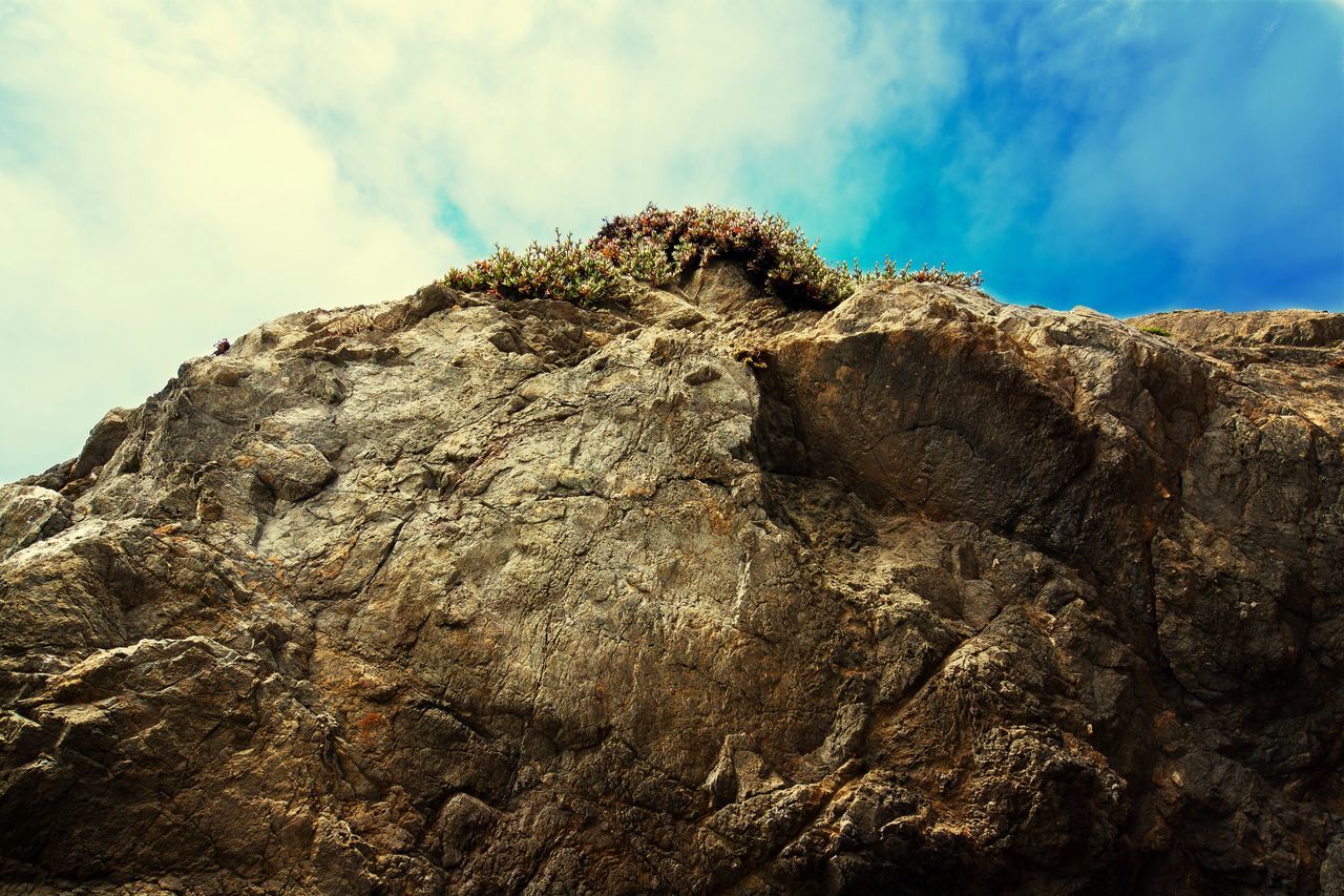 sky, low angle view, textured, rock formation, rough, nature, tranquility, rock - object, tree, tranquil scene, beauty in nature, scenics, geology, day, outdoors, rock, cloud - sky, rocky mountains, no people, tree trunk