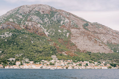 Scenic view of sea and mountains against sky