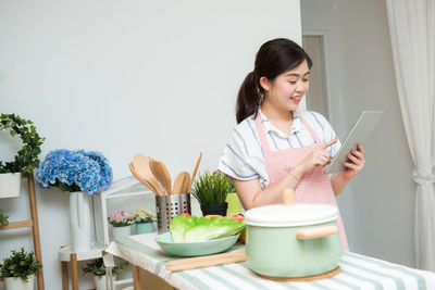 Woman holding food on table