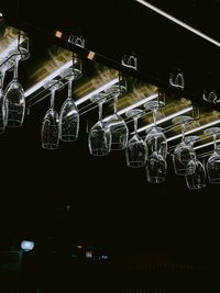 Low angle view of wine glasses hanging in restaurant