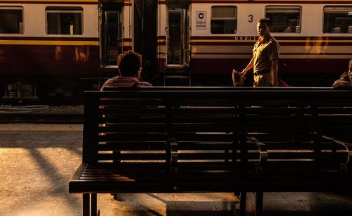 People sitting on railroad station platform