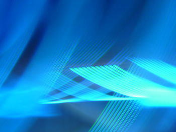 Digital composite image of illuminated light against blue background