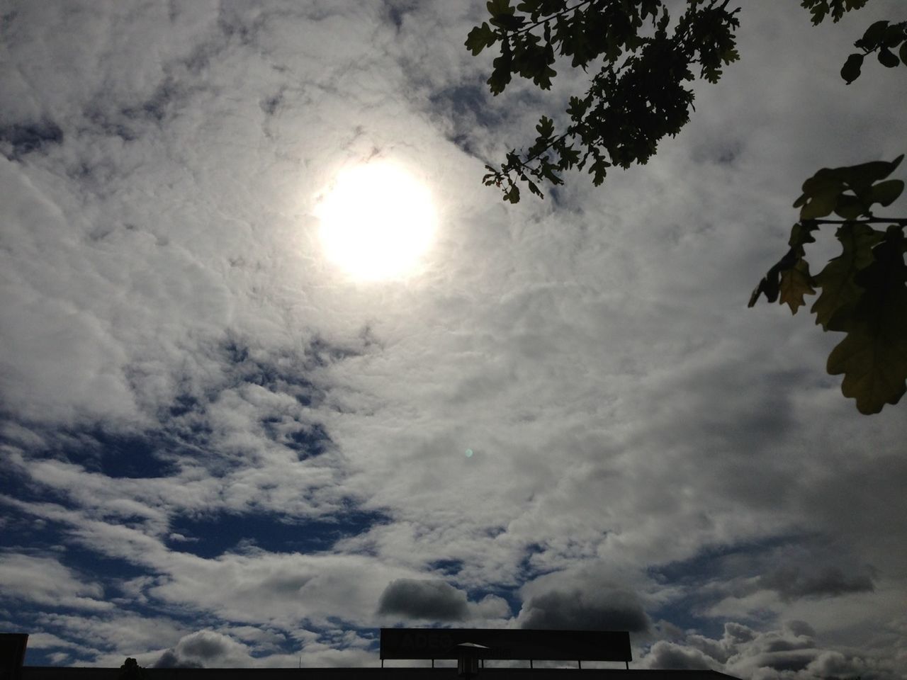 sky, cloud - sky, sun, low angle view, cloudy, silhouette, sunlight, tree, nature, sunbeam, cloud, beauty in nature, tranquility, scenics, sunset, weather, no people, outdoors, tranquil scene, lens flare