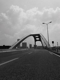 Bridge over road against sky in city