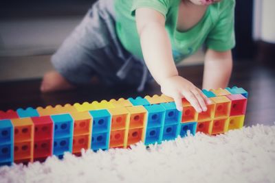 Boy playing with toy at home