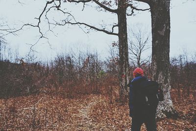 Woman standing by tree