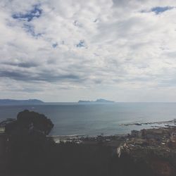 Scenic view of sea against cloudy sky