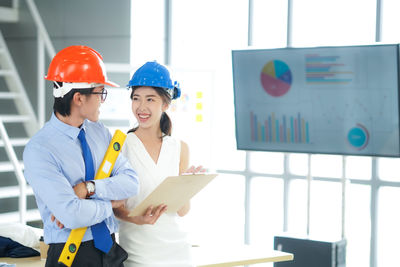 Portrait of architects standing in city