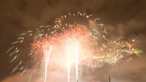 Low angle view of firework display at night