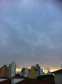 Buildings against cloudy sky