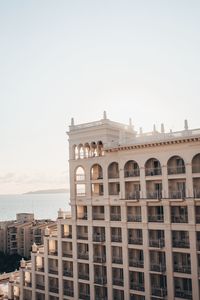 Buildings in city against clear sky