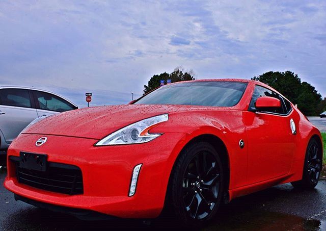 transportation, mode of transport, land vehicle, car, red, sky, travel, cloud - sky, stationary, road, parking, cloud, outdoors, street, on the move, no people, day, part of, tree, parked