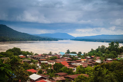 High angle view of townscape by mountains against sky