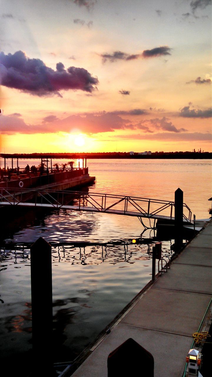 sunset, water, sea, scenics, sky, silhouette, tranquil scene, transportation, tourism, tranquility, beauty in nature, travel destinations, dusk, cloud - sky, mode of transport, vacations, nature, idyllic, sun, moody sky, non-urban scene, orange color, dramatic sky, cloud, atmosphere, sunbeam, development, dock