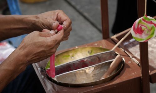 Midsection of woman holding ice cream