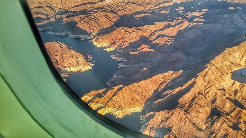 Aerial view of landscape seen through airplane window