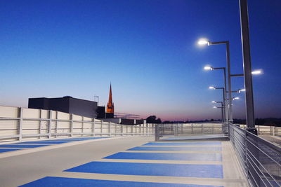 Illuminated rose lane car park against clear sky at dusk