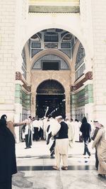 Group of people walking in front of building