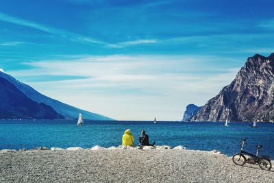 People on beach against sky