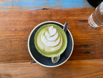 High angle view of coffee on table, matcha latte