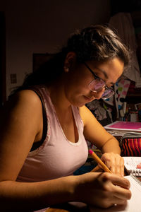 Young girl studying in her room