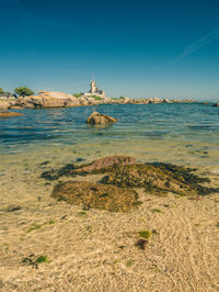 Scenic view of beach against blue sky