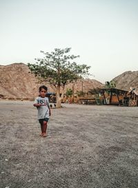 Full length of woman standing against clear sky