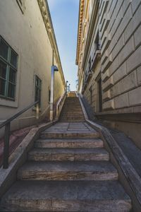 Low angle view of stairs along buildings