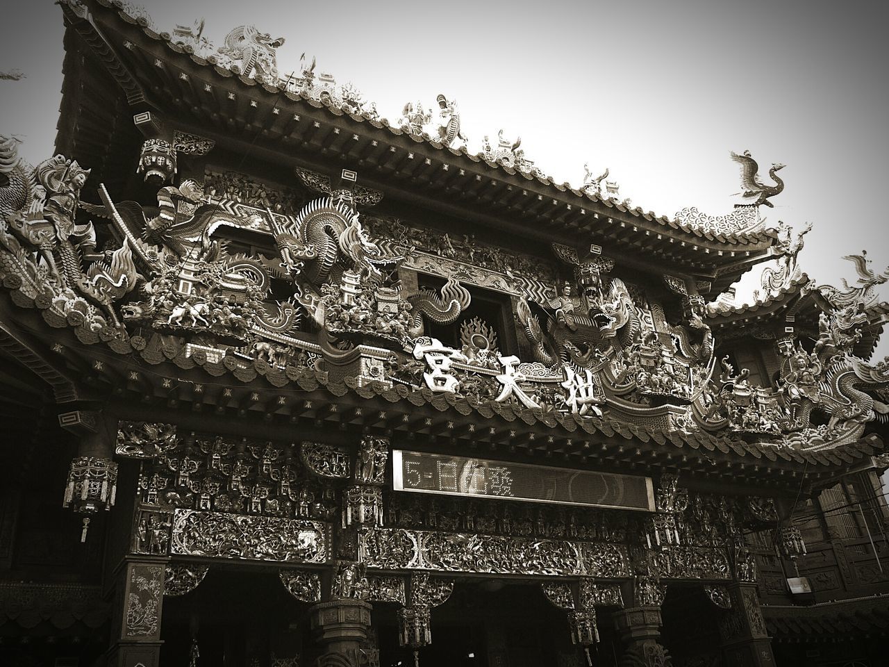 low angle view, built structure, architecture, building exterior, clear sky, roof, religion, place of worship, spirituality, house, day, no people, window, outdoors, sky, art and craft, temple - building, building, old, ornate