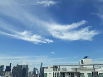 Low angle view of buildings against blue sky