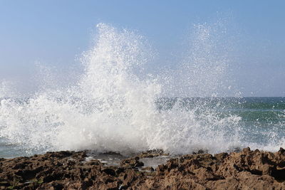 Waves splashing on rocks at shore