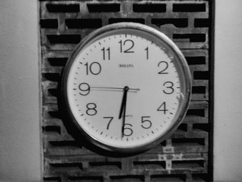 Close-up of clock on white wall