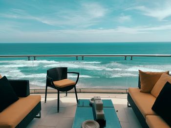 People at beach against sky