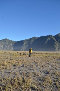 Rear view of man standing on land