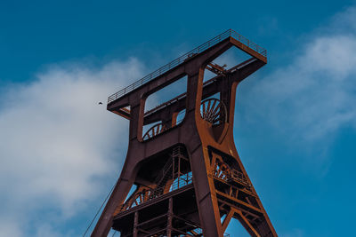 Low angle view of tower against cloudy sky