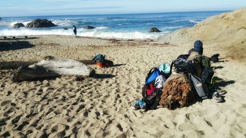 Panoramic view of people on beach against sky