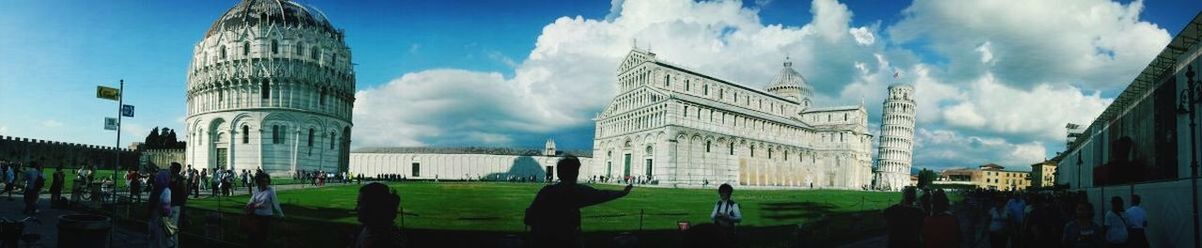 architecture, building exterior, built structure, sky, cloud - sky, cloud, blue, low angle view, travel destinations, day, grass, city, famous place, church, cloudy, sunlight, tower, panoramic, religion, outdoors