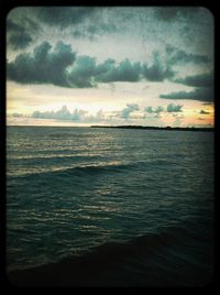 Scenic view of sea against cloudy sky